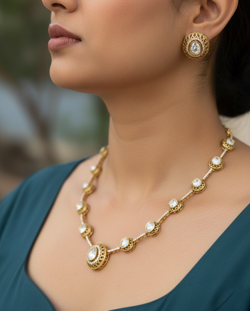 Woman wearing a gold necklace and earrings with a blurred natural background