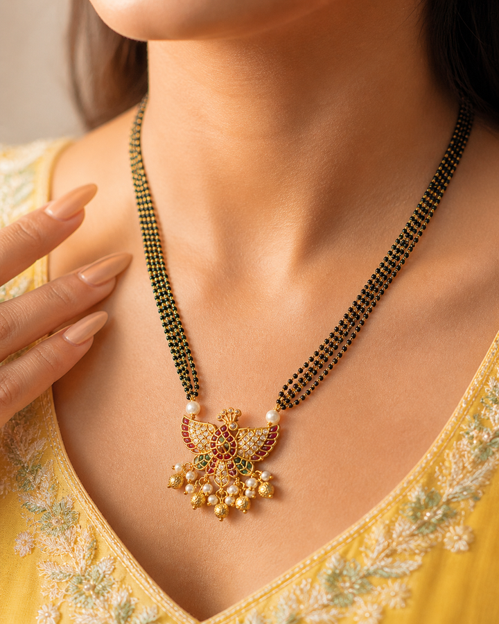 Woman wearing a gold necklace with a yellow top