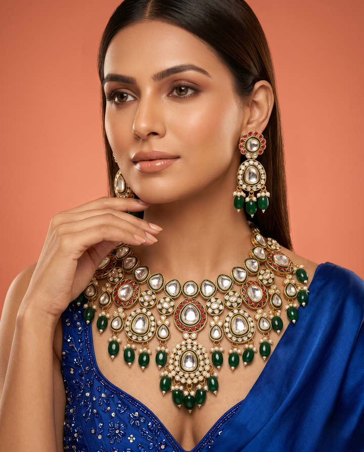 Woman wearing a luxurious necklace and earrings with a blue outfit on an orange background