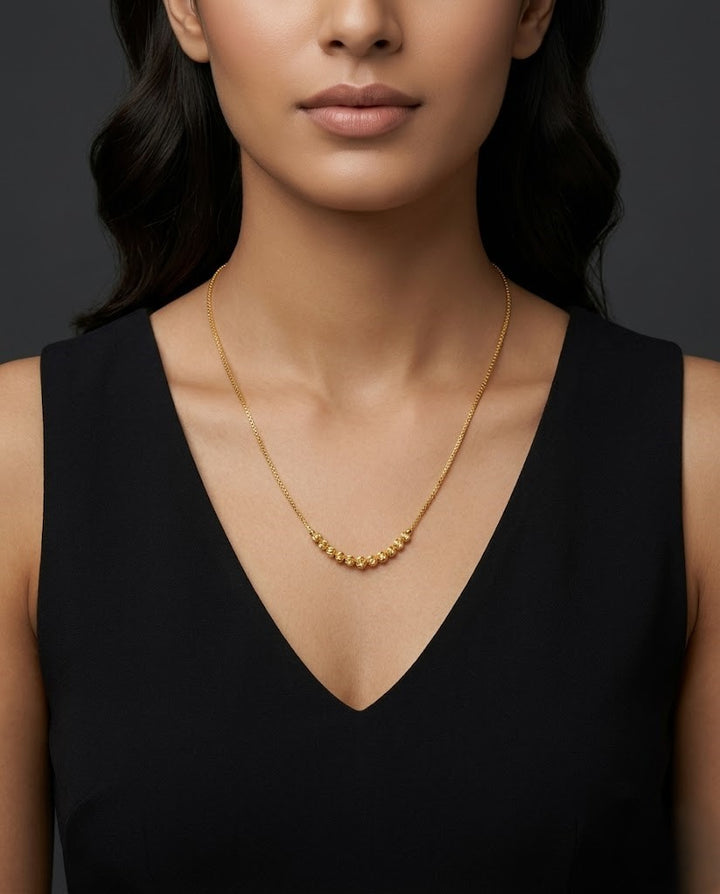 Woman wearing a necklace against a dark background
