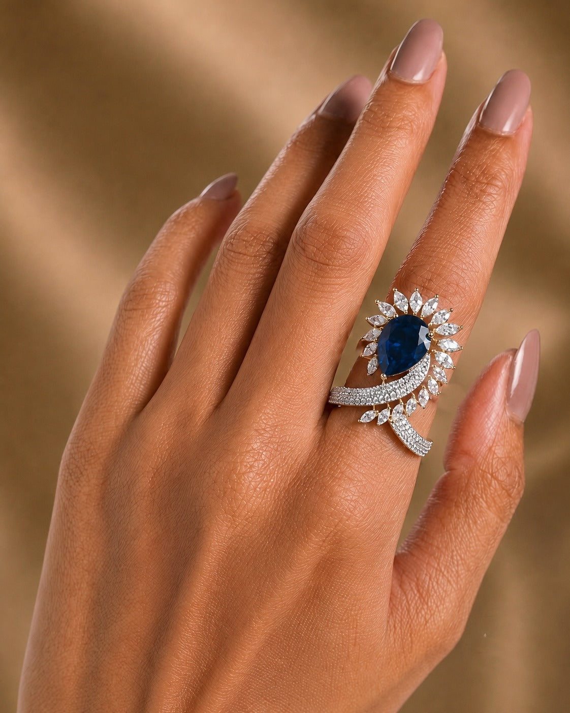 deep navy blue ring wear by women  with beige golden  background 