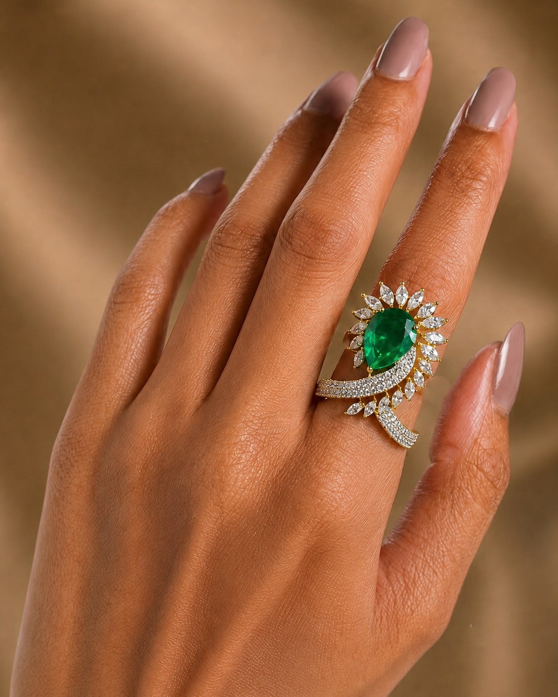 emerald green  ring wear by women  with beige golden  background 