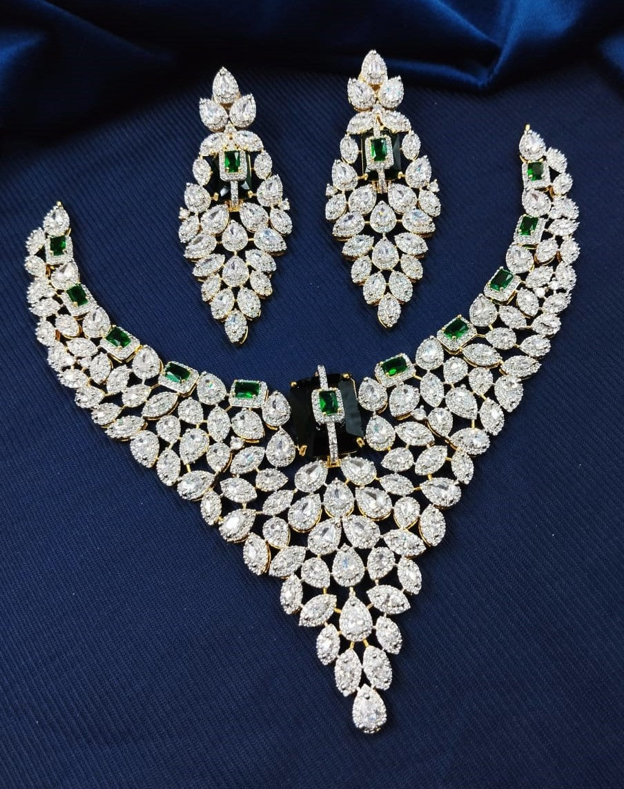 Jewelry set with necklace and earrings on a blue fabric background