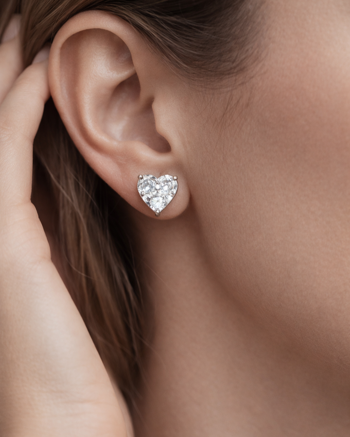 Heart-shaped diamond earring worn by a person