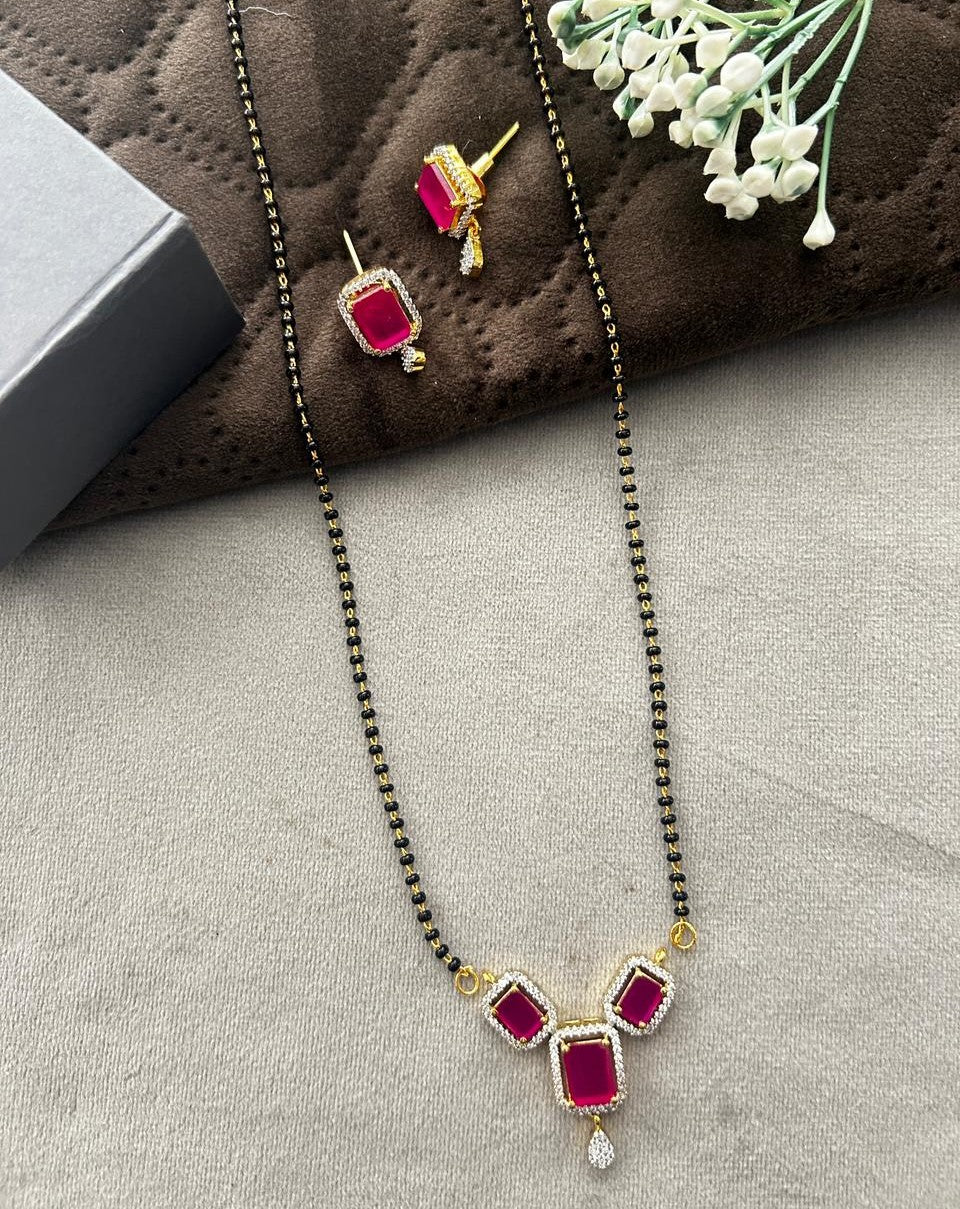 Jewelry set with necklace and earrings on a textured surface
