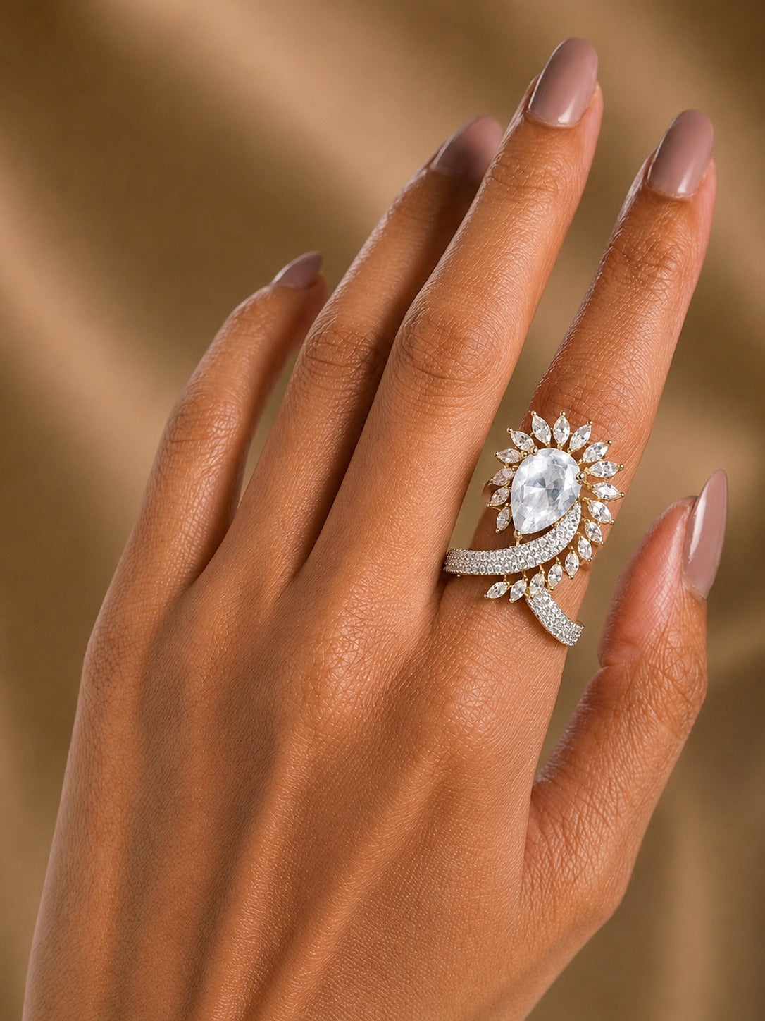 white  ring wear by women  with beige golden  background 